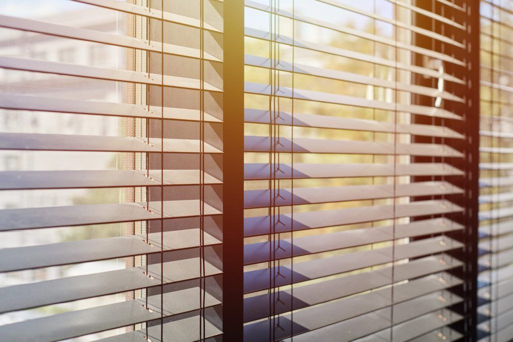 Venetian Blinds with sun shining through | Featured image for Different Types of Venetian Blinds