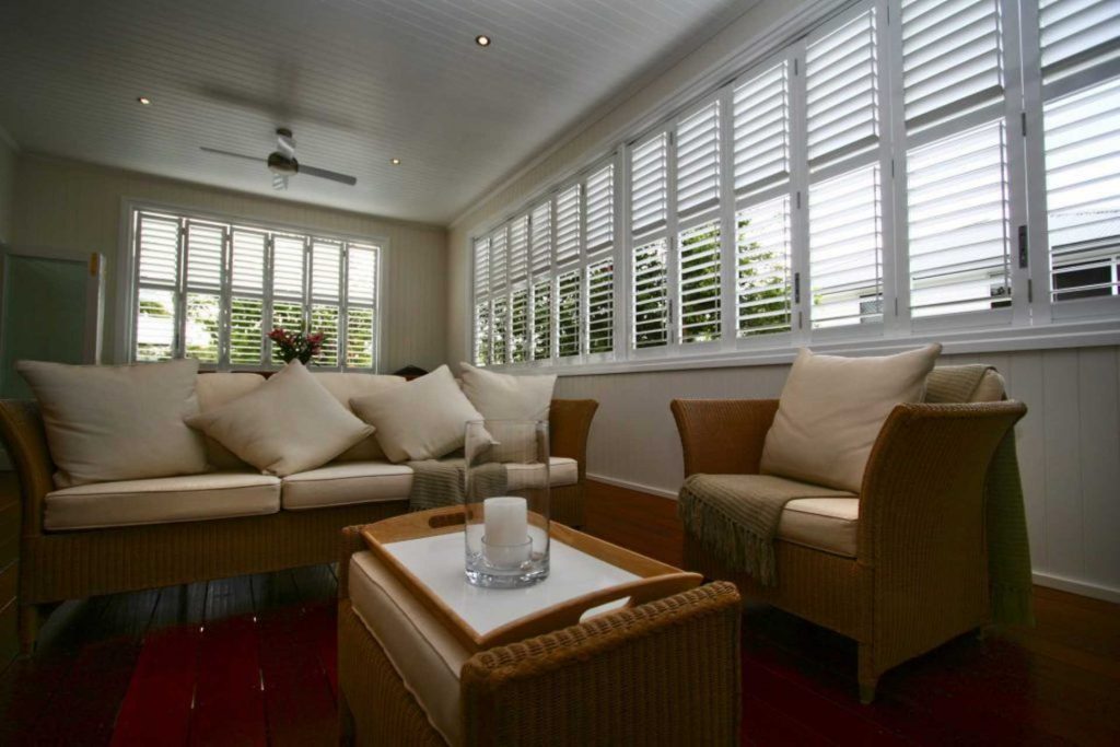 Modern sun room with aluminium plantation shutters | Featured image for the Different Types of Shutters blog from Cosmopolitan Shutters.