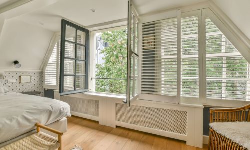 Shutters in the bedroom | Featured image for the Gold Coast Location Page from Cosmopolitan Shutters.